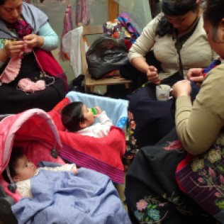 Indigenous Village Zinacantan -- local women embroidering with their babies